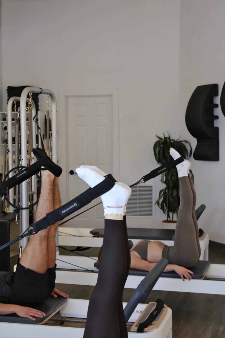 Legs raised in the Reformer foot straps